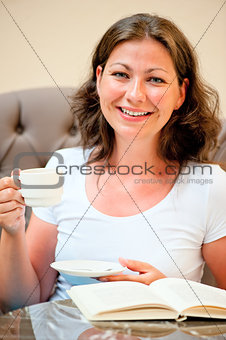 woman with a cup of coffee smiling