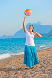 beautiful girl playing on the beach ball