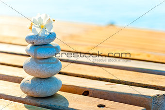 wooden planks of the pier and a pile of stones