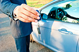 man-manager transmits the key to the new car buyer