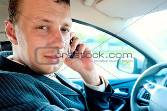 Portrait of a man driving a car with the phone