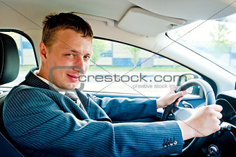 Portrait of a businessman driving a car