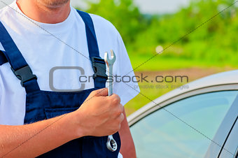 mechanic in a suit with a wrench