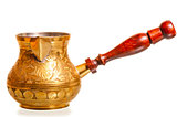 brass coffee pot with wooden handle on a white background