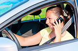 woman driving a car talking on the phone