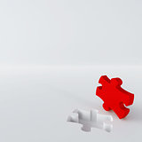 red puzzle in the corner of white surface
