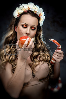 Woman with red apple and snake