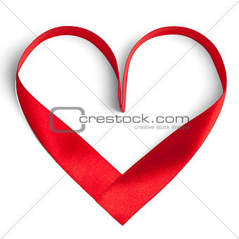 Red ribbon in a heart shape isolated on white.