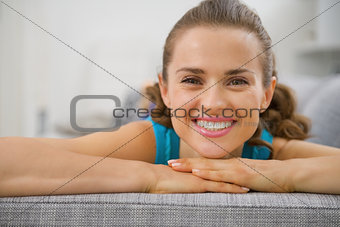 Portrait of smiling young woman in living room