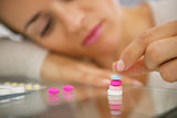 Closeup on young woman playing with pills