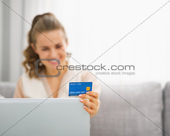 Closeup on young housewife making online shopping