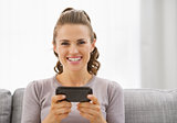 Happy young woman reading sms