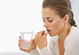 Young woman eating pills