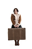 low smiling girl with a large suitcase