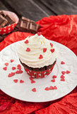 Chocolate cupcake decorated with red hearts