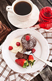 Chocolate muffin served with cream and fresh berris