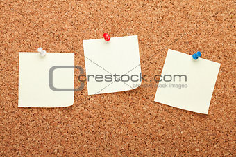 Blank postit notes on cork notice board