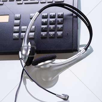 office desk with telephone and headset objects 
