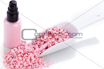 pink body lotion in dispenser and aroma salt isolated