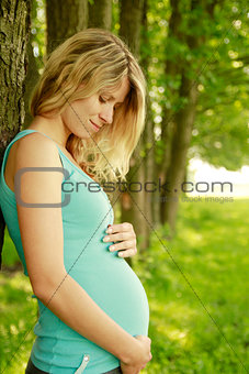 young pregnant girl on the nature 