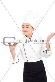 Chef  holding tray and smelling something
