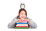  happy young student looking clock with books 