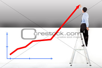 businessman standing on ladder drawing diagrams