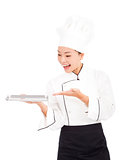 asian woman chef holding tray and showing