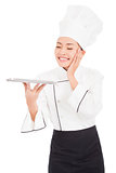 satisfied woman chef holding tray