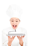 young woman chef looking tray with amazing expression