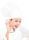 Pretty woman chef baker or cook showing ok hand sign
