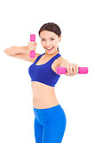 Young woman working out with dumbbells in her hands