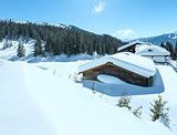 Winter sunny mountain and wood house