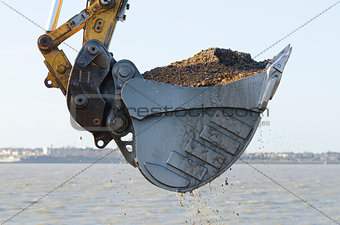 Excavator dredging a harbor