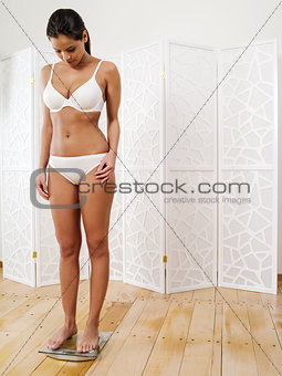 Sexy woman standing on a scale