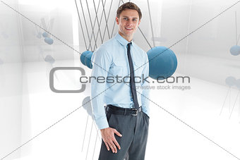 Composite image of smiling businessman standing with hand in pocket