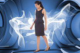 Composite image of asian businesswoman walking