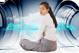 Composite image of businesswoman sitting cross legged frowning