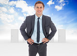 Composite image of cheerful businessman standing with hands on hips