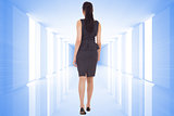 Composite image of businesswoman walking