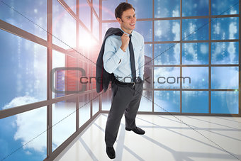Composite image of smiling businessman holding his jacket
