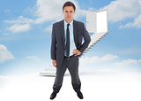 Composite image of stern businessman standing with hand on hip