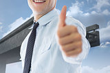 Composite image of businessman showing thumbs up