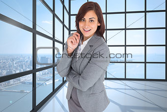 Composite image of smiling thoughtful businesswoman