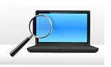 Laptop computer under magnifying glass