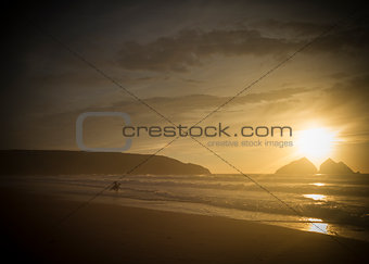 silhouette of a surfer at sunset