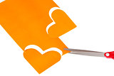 Two paper orange heart shapes cut out of paper