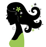 Beautiful woman silhouette with flowers in hair