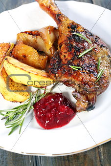 Duck leg with potatoes and cowberry sauce. 
