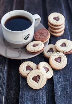 Cup of coffee and heart shaped cut out cookies 